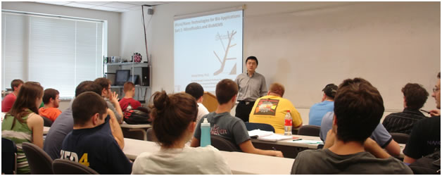 Dr. Zheng talking with high school students