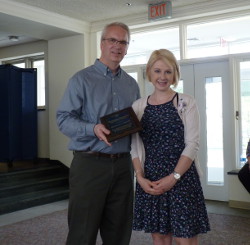 Peter Butler and Monica Corsetti holding award