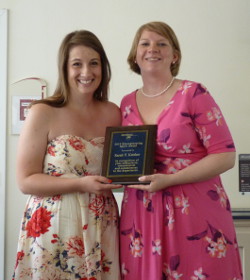 Sarah Krisher and Maggie Slattery holding award