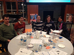 Several grad students sitting around table.