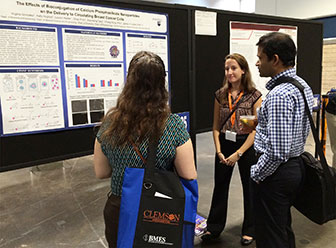 Virginia Gonzalez in front of poster at BMES national meeting